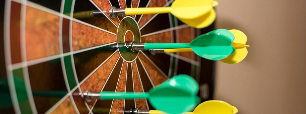 Green and Yellow Darts on Brown-black-green-and-red Dartboard